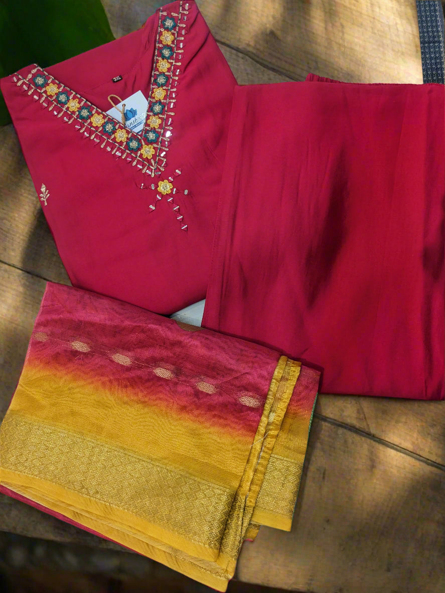 "Vibrant pink Roman silk suit with multicolour embroidery and ombre organza dupatta"

"Flat lay of pink silk suit set with yellow-pink organza dupatta"