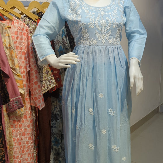 Light blue kurta set with embroidered white dupatta displayed on mannequin